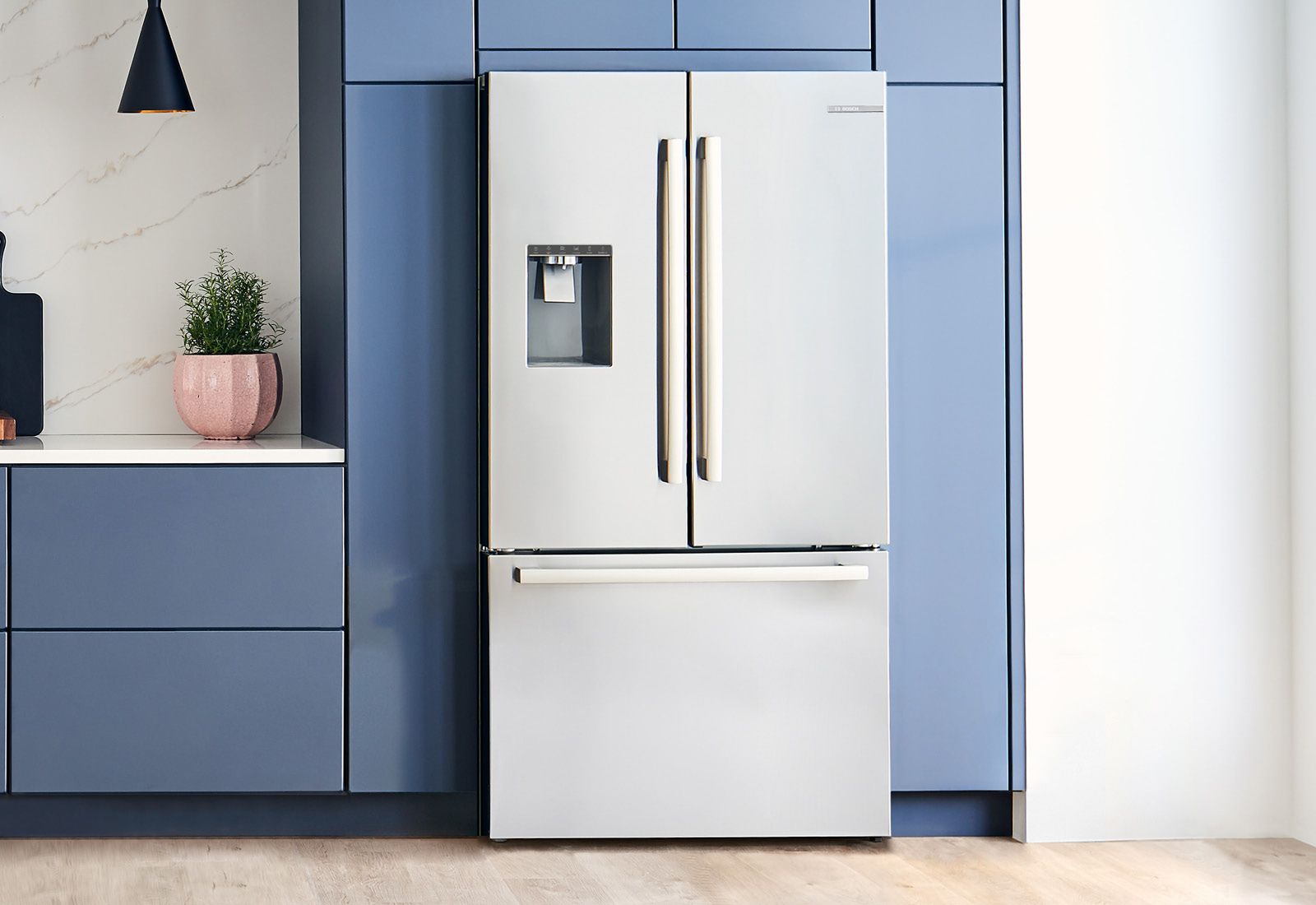 Credit: Bosch A Bosch French door refrigerator shown in a blue-themed kitchen