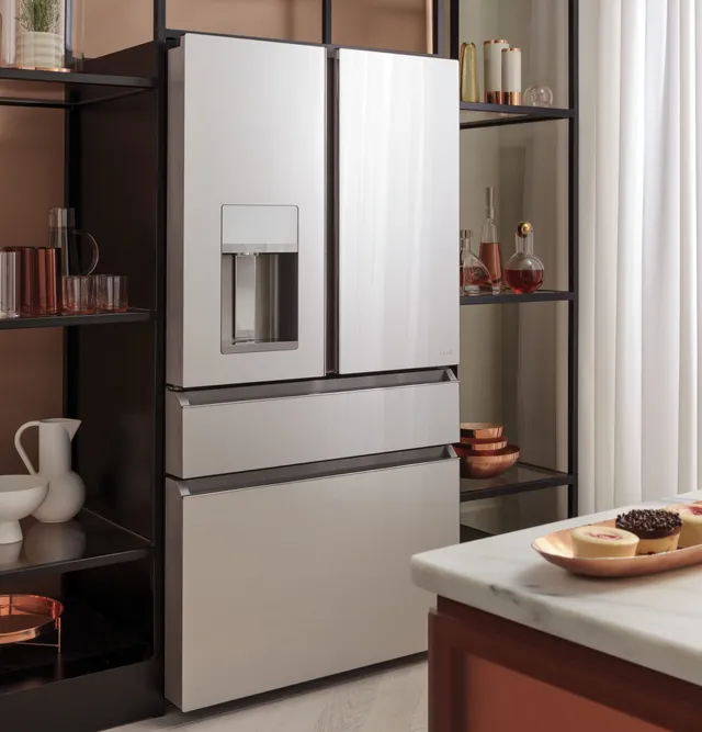 The Café CVE28DM5NS5 refrigerator in a kitchen with décor 