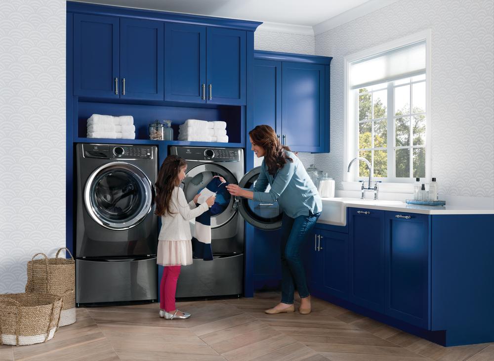 mother and daughter unload clothing from Electrolux front load dryer