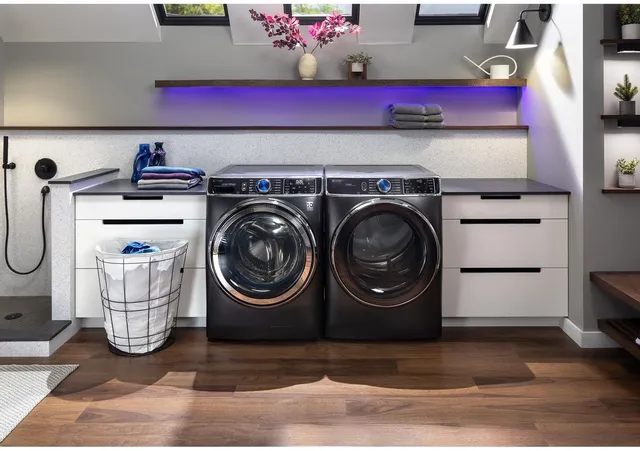 A modern laundry room with purple LED lights and a matching GE Profile front load washer an dryer pair 
