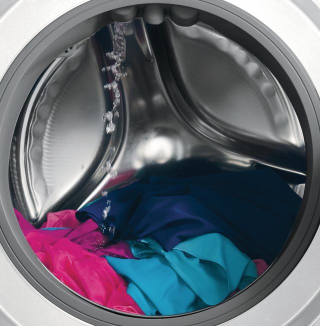 Front view of a front load washing machine tumbling clothes