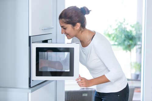 Using a Microwave Drawer Woman Using a Microwave Drawer