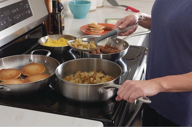 Close view of someone cooking breakfast on an electric stove Close view of someone cooking breakfast on an electric stove