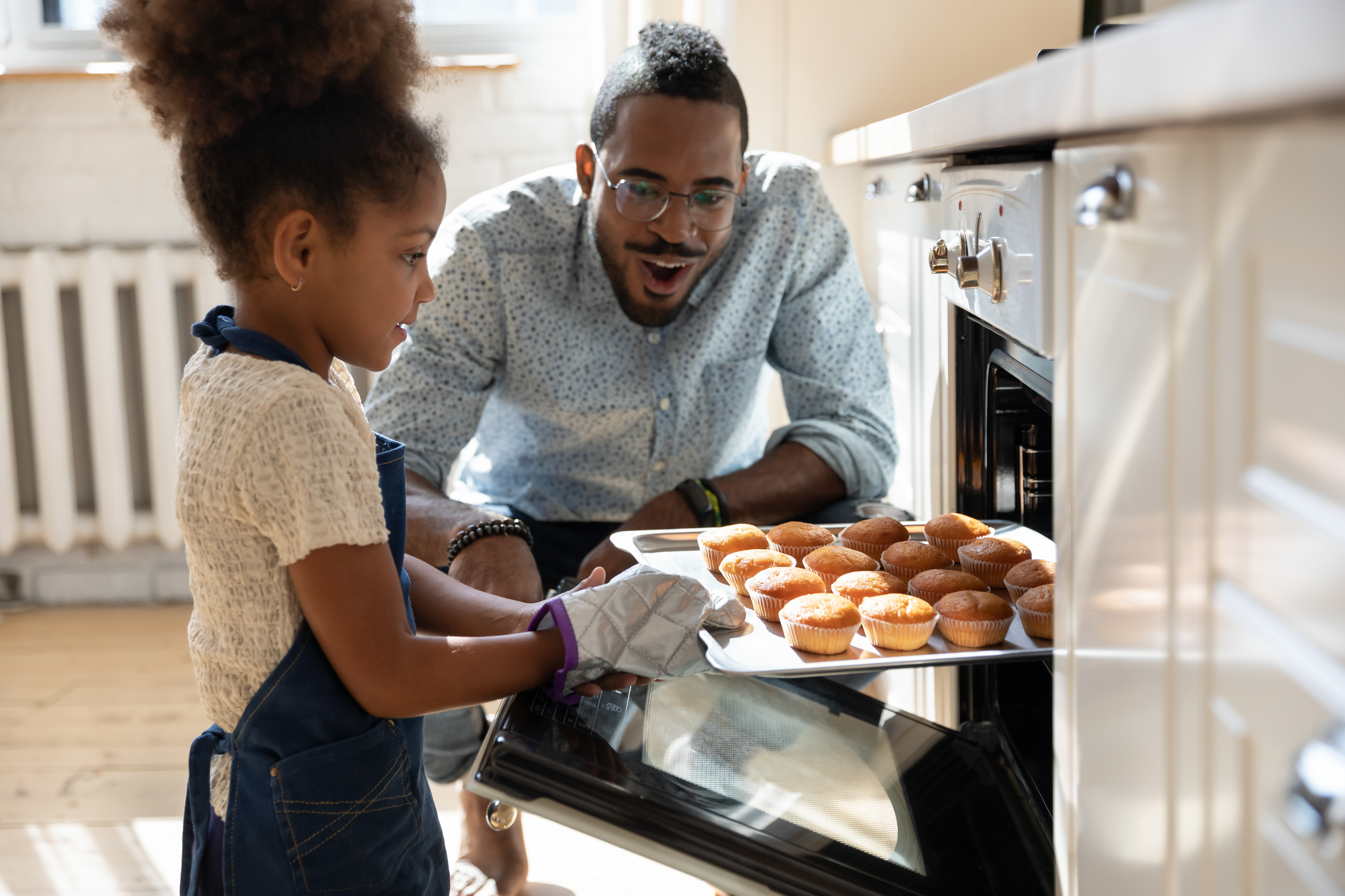 iStock Credit: fizkes Father and daughter baking