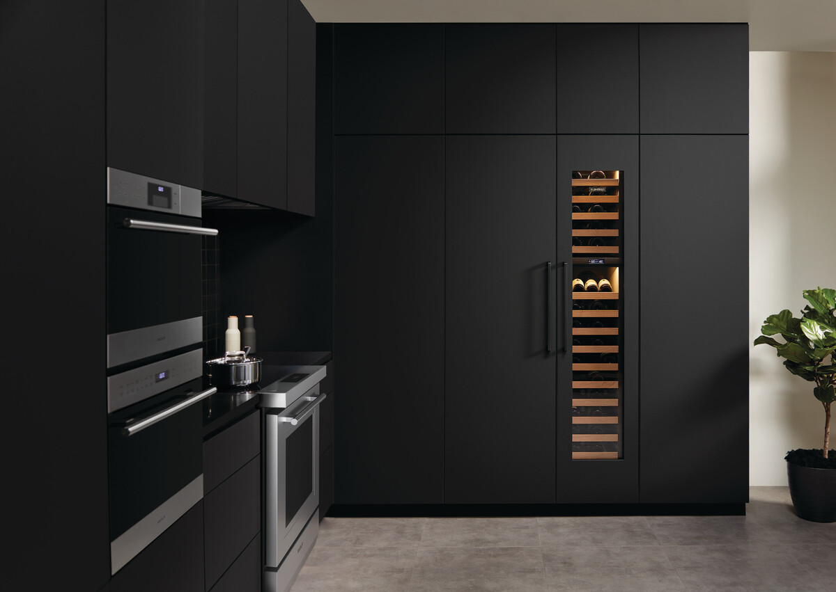 luxury kitchen with built-in Sub-Zero black-paneled column fridge and wine cooler