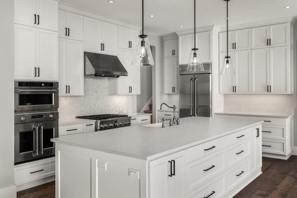 iStock Credit: hikesterson A modern white kitchen with stainless steel appliances