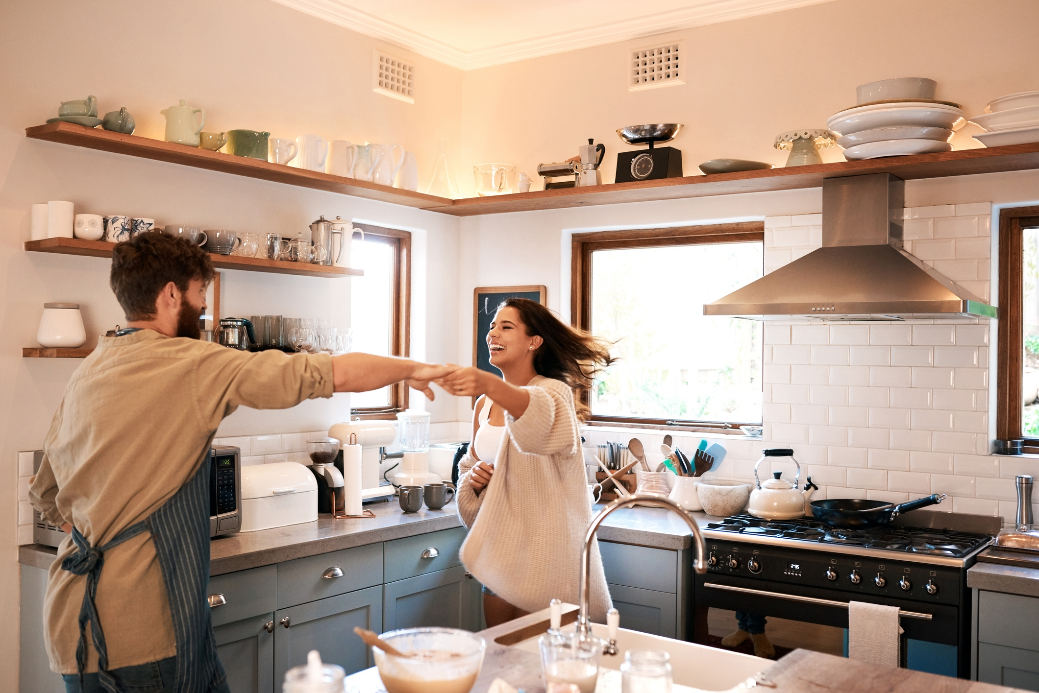 PeopleImages young couple dancing together in the kitchen