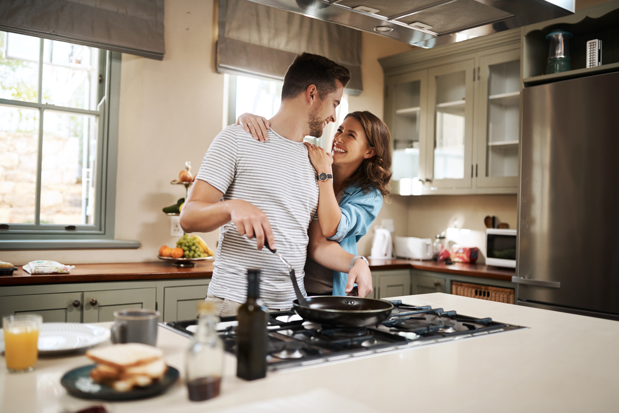 PeopleImages happy couple making breakfast together