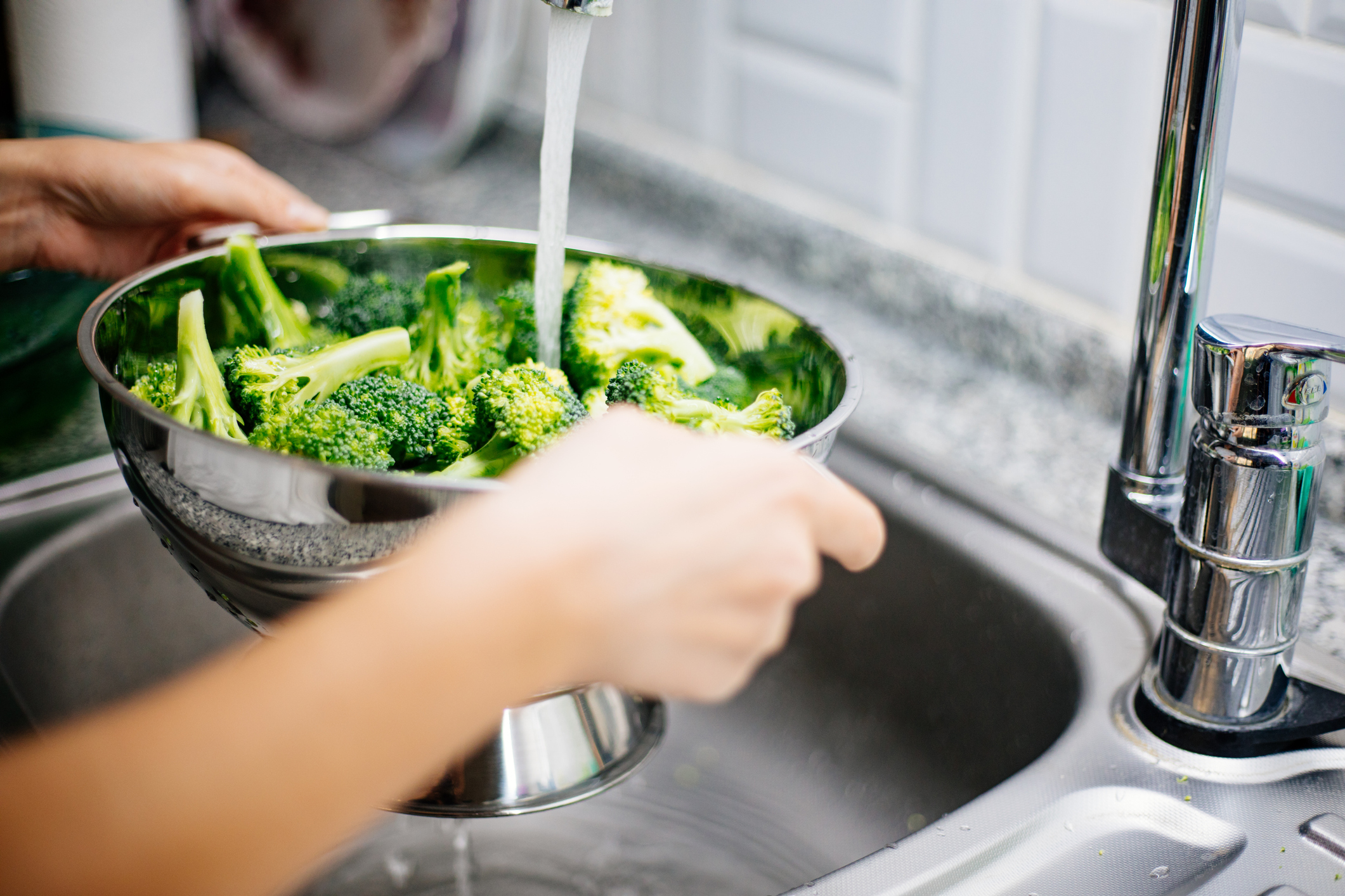 rinsing broccoli in the kitchen sink