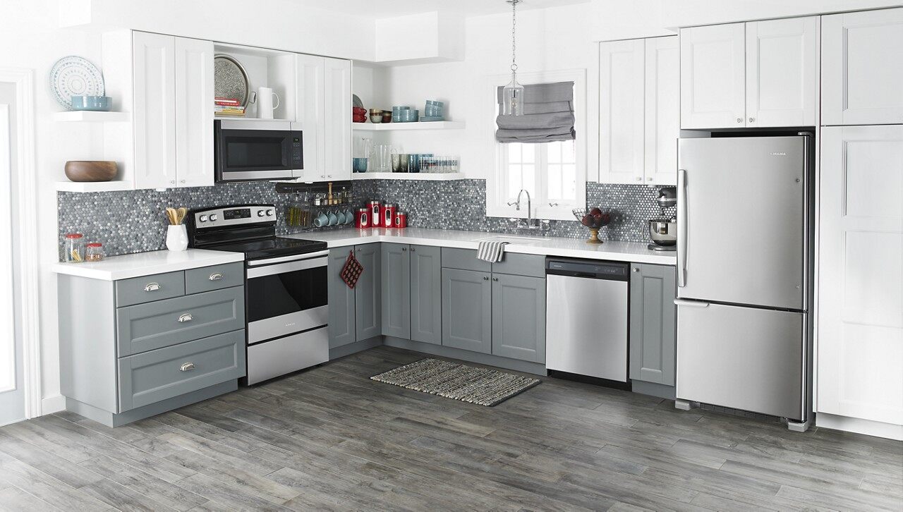 A modern kitchen featuring an Amana range, microwave, refrigerator, and dishwasher