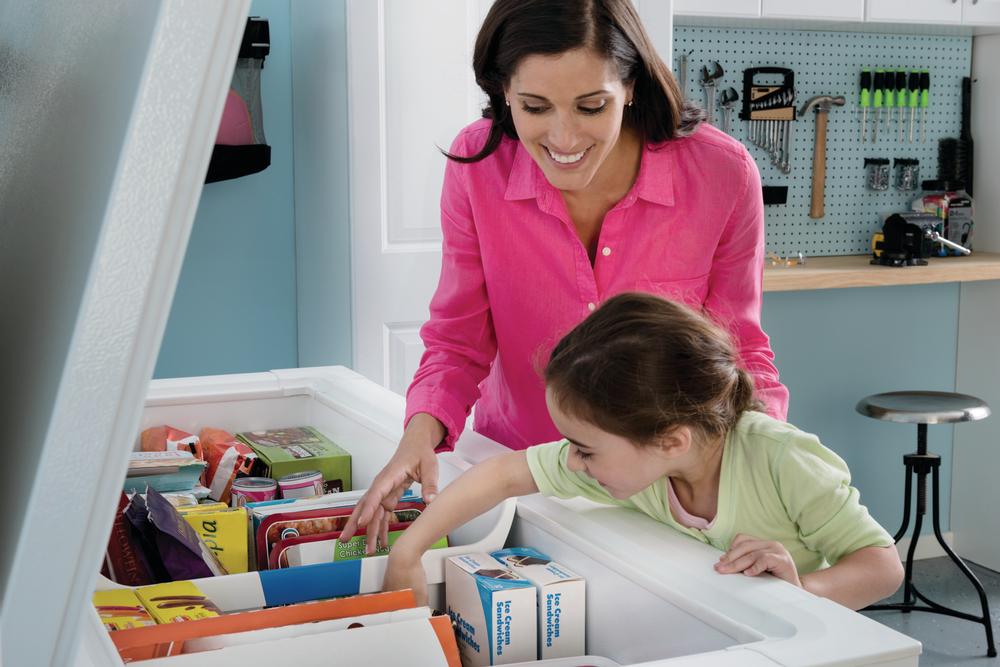 mother retrieves frozen snacks for her children