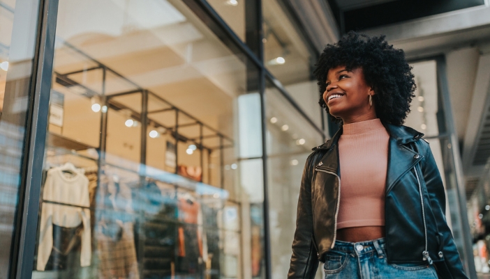 woman smiling outside retail space with lighting