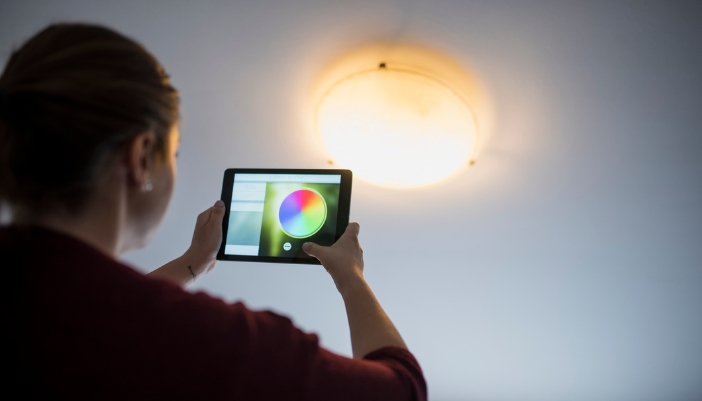 Woman messing with the color-tuning on her white lights