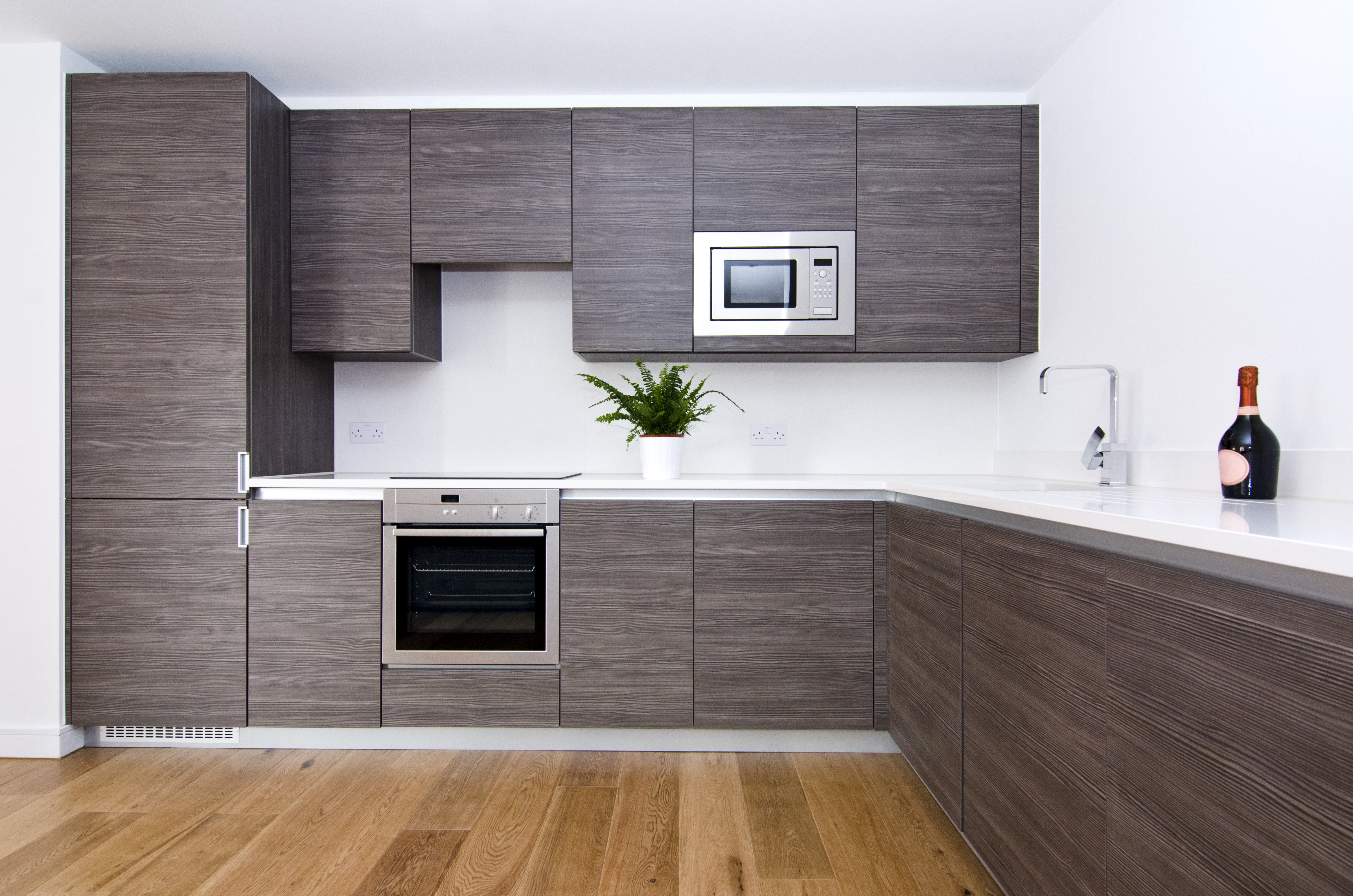 Wide shot of renovated kitchen with modern wooden cabinetry