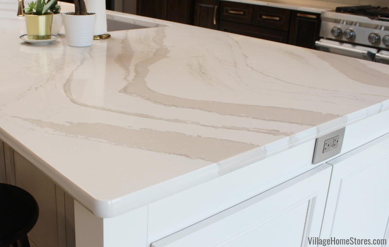 Closeup shot of edge of kitchen island countertops in Brittanicca Warm Cambria Quartz and standard eased edge style.