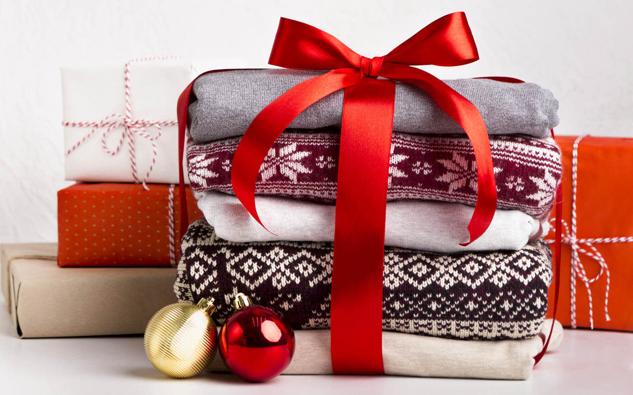 Credit:Prostock-Studio stack of Christmas sweaters tied in gift wrap