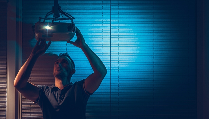 Man positioning/installing a projector