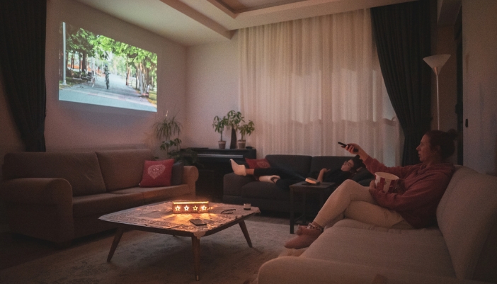 Group of friends watching TV on their projector