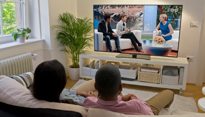 Couple watching TV in the daytime with minimal glare on the screen