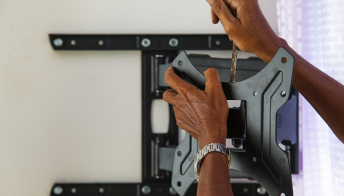 Elec_TV-Mounting-101_3.jpg Closeup of someone installing a wall mount