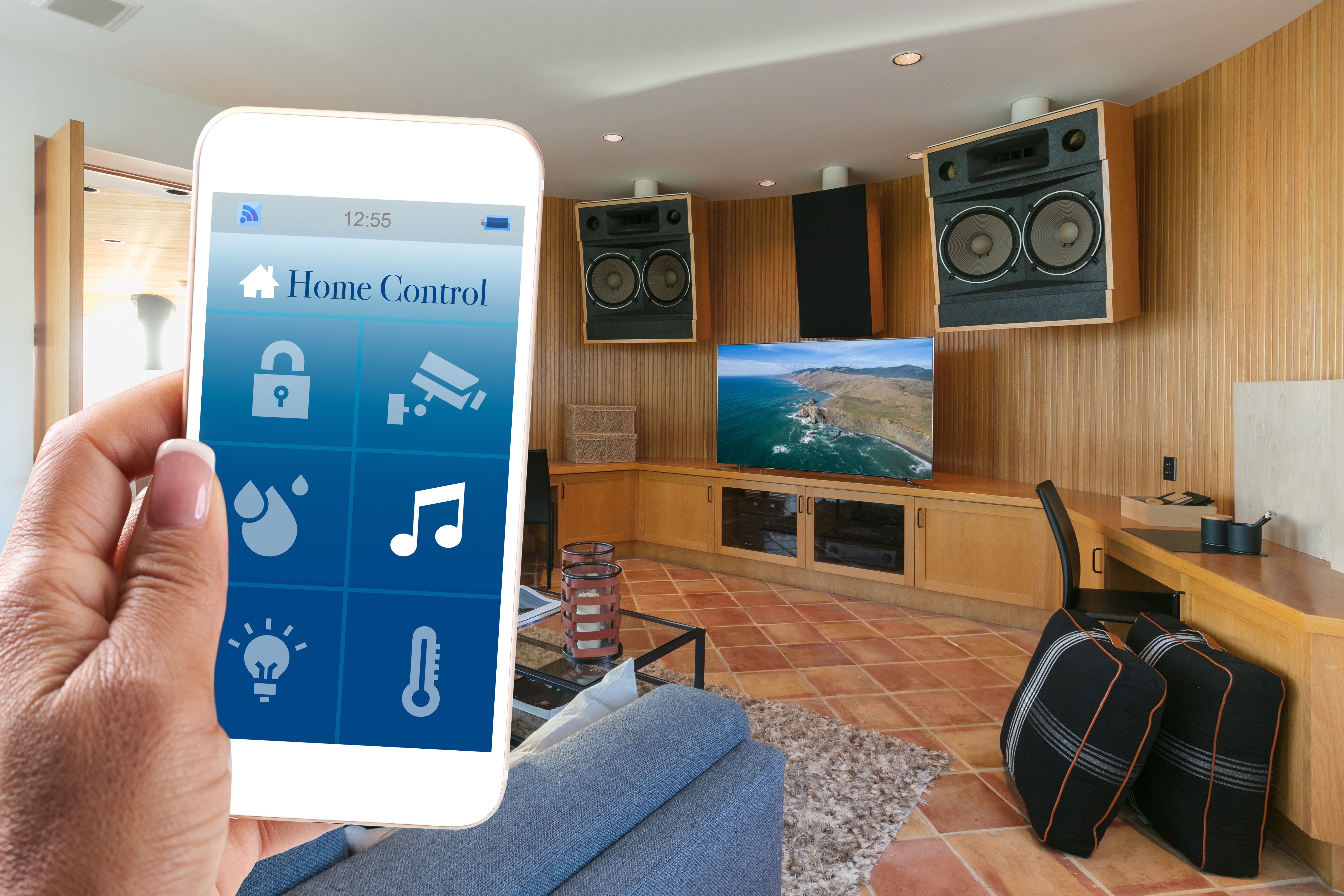 A person using a smart device to control a wireless home audio system 