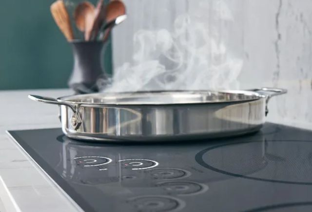 Close view of a shallow pan heating on an induction cooktop