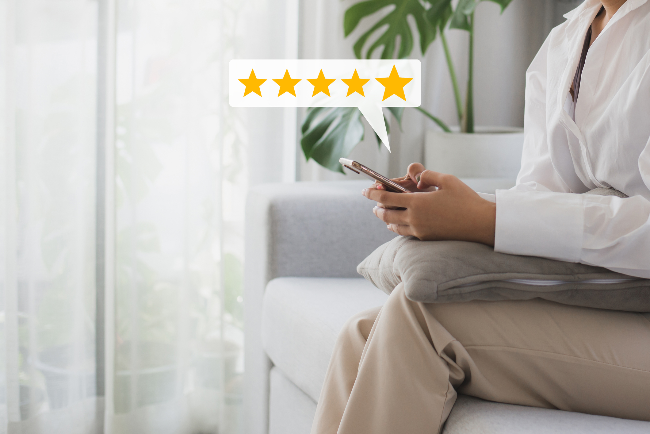 A graphic of a person giving a 5-star review on a sofa