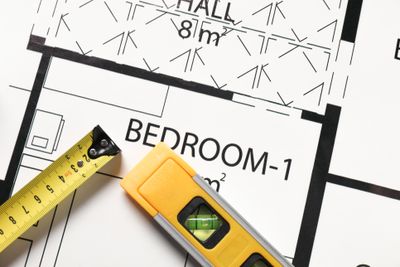 iStock Credit: Olga Yastremska Overhead view of bedroom blueprint & tools