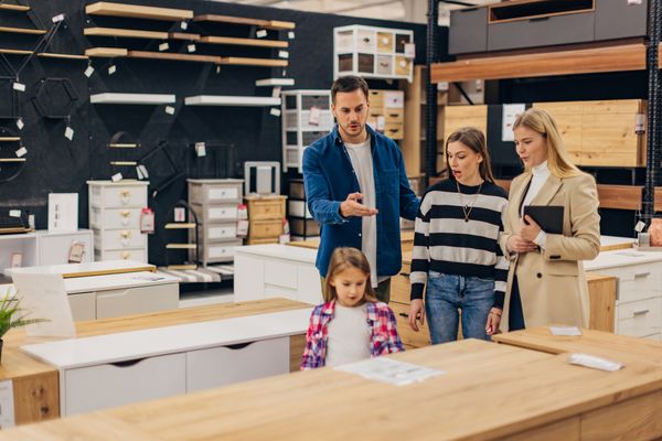A family reviewing cabinets in a store