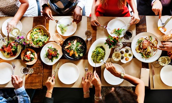 iStock Credit: Rawpixel Ltd Overhead view of various diners at a table