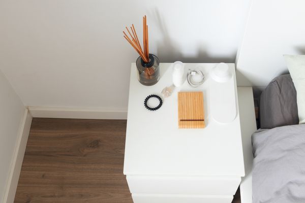 Overhead view of a white nightstand with décor 