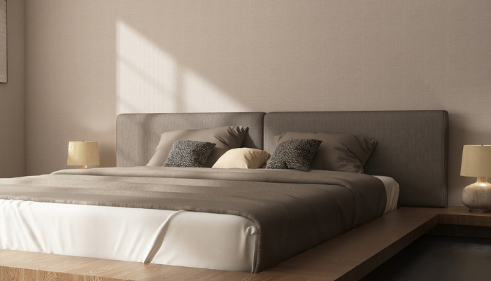 A platform bed in a modern home with the sun shining on it.