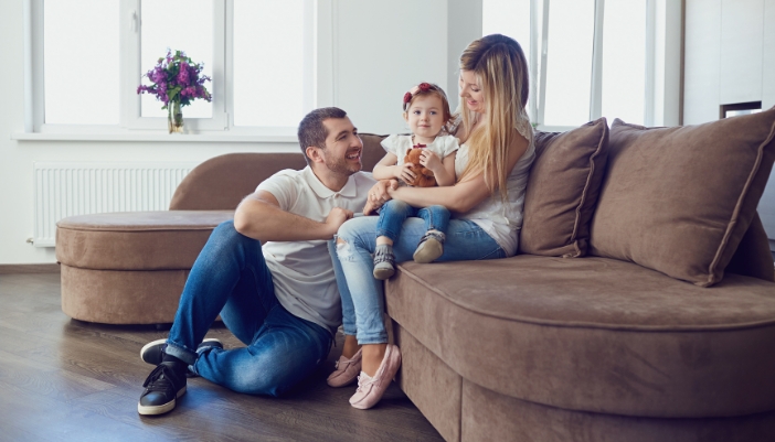 Furn_Childproofing-Furniture_4.jpg A young family laughing around a curved sofa chaise
