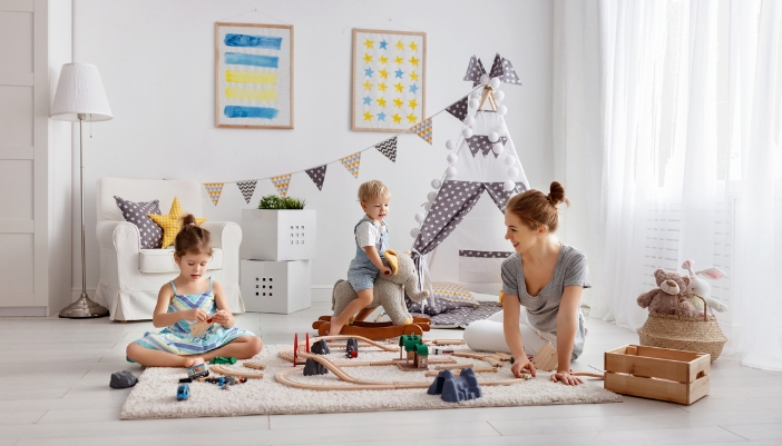 Furn_Childproofing-Furniture_5.jpg A mother and two children playing on the floor with an anti-slip rug