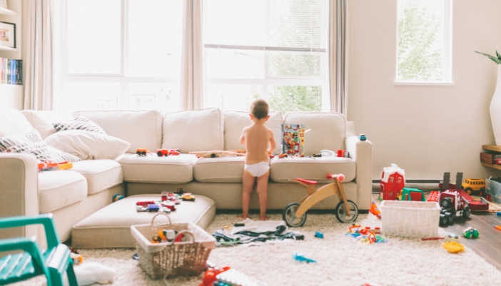 Furn_Childproofing-Furniture_6.jpg A toddler playing with big blocks all over a childproofed living room