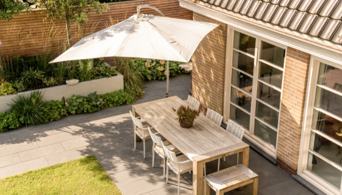 Furn_outdoor-furniture-summer-guide_3.jpg A back patio with a dining area and shade