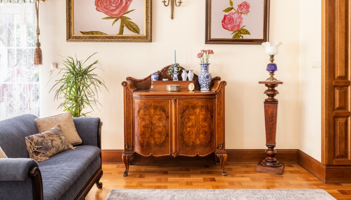 An antique cabinet sits in a modern living room. 