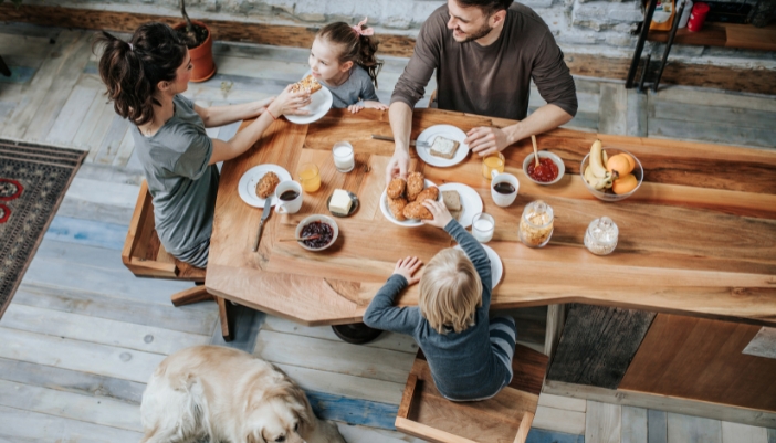 n overhead view of a family eating at an oddly shaped table.