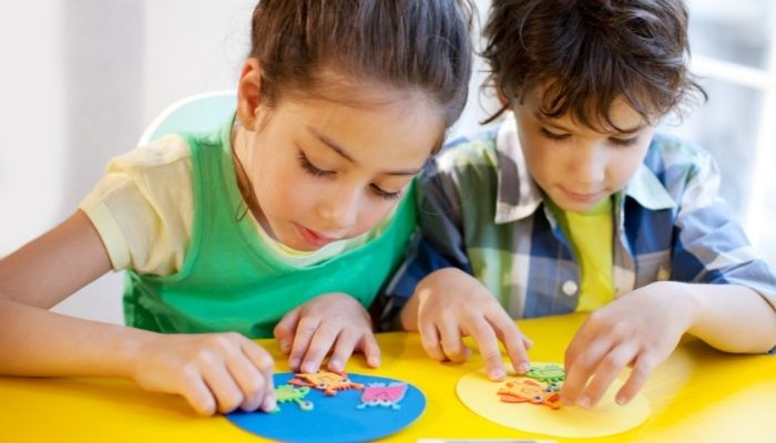 Furn_Summer-Kids-Activities_1.jpg Boy and girl doing a crafting activity