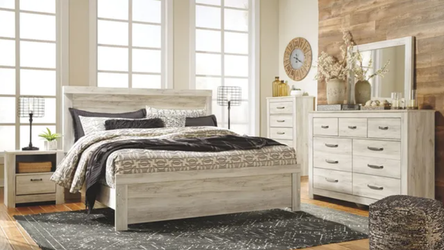 front view of a modern farmhouse style bedroom with whitewashed wood furniture