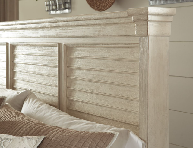 close view of a whitewashed engineered wood king bed frame headboard