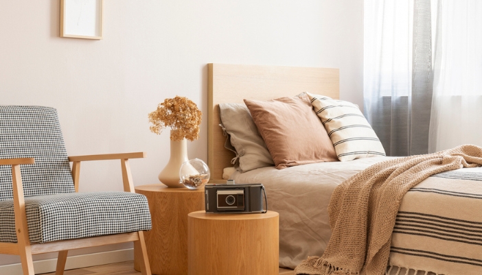 Brightly lit, boho-inspired bedroom with natural tones and layered textures.