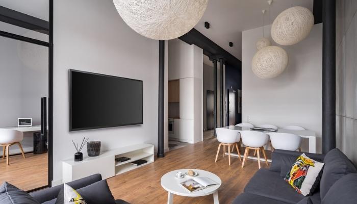 Stylish living room with ball lampshades and hanging tv