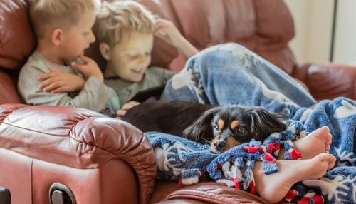 Kids Relaxing on Recliner Brothers and Their Dog Sitting on a Recliner