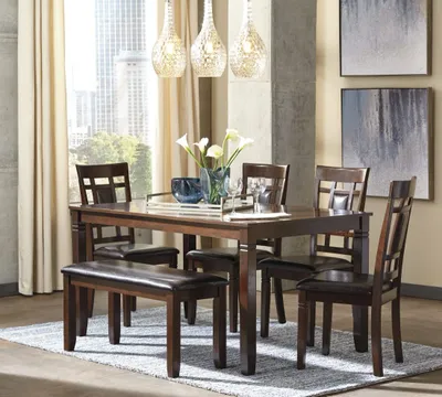 Credit: Signature Design by Ashley The Signature Design by Ashley 6-piece Bennox dining set with bench in a modern dining room