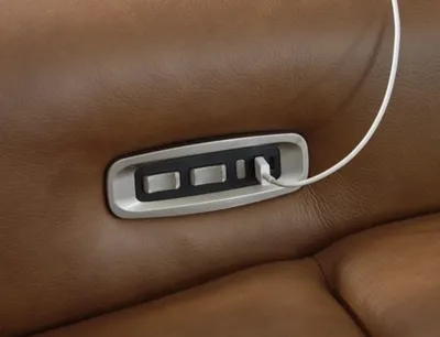 A close-up of the Signature Design by Ashley Magic Man recliner sectional controls