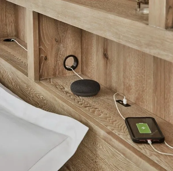 Credit: aspenhome A close-up of electronics on the aspenhome Modern Loft bookcase bed headboard