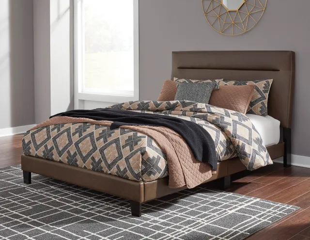 The Signature Design by Ashley Adelloni collection queen upholstered bed frame with geometric bedding 
