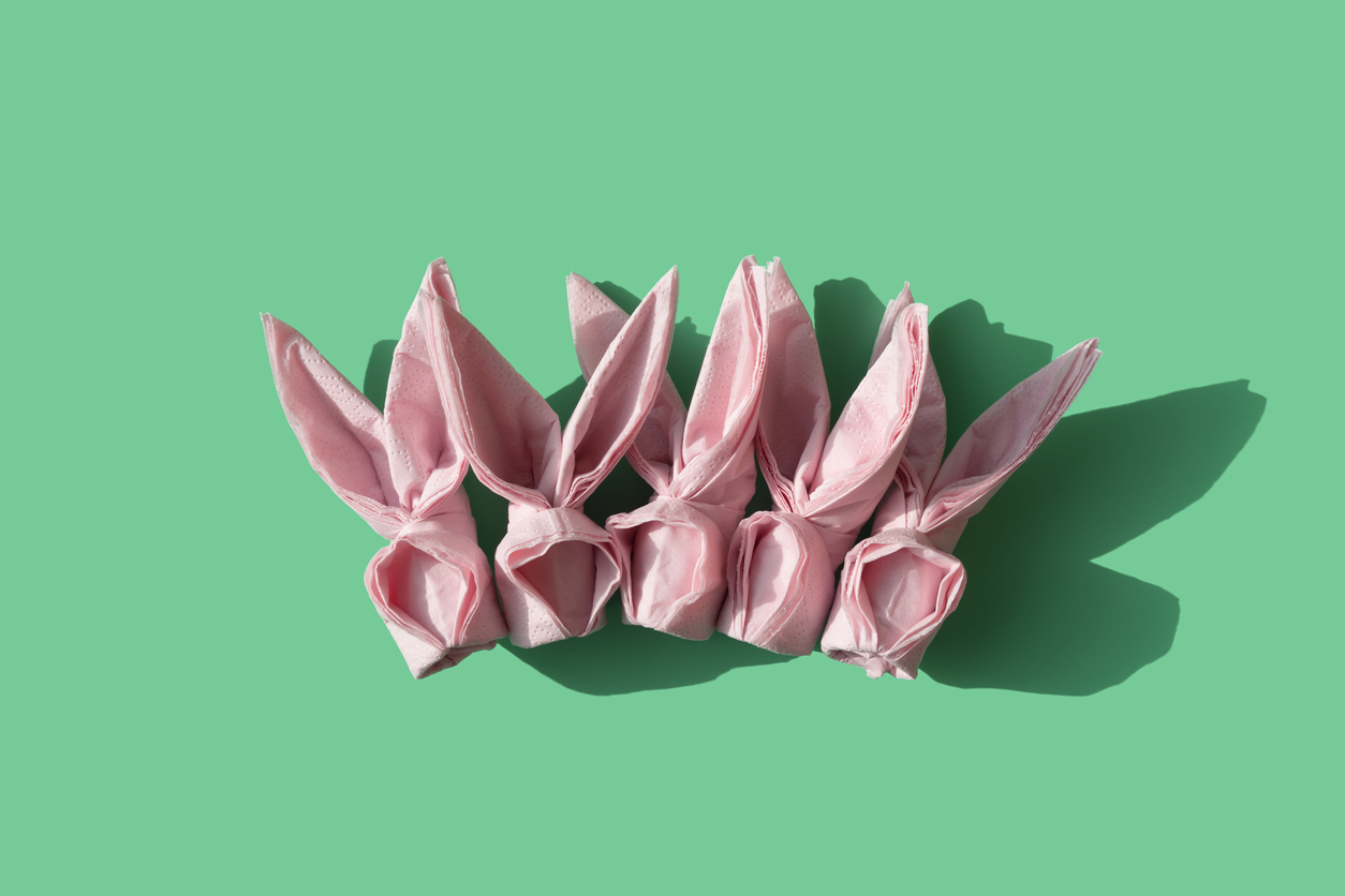 iStock Credit: schlosann pink origami paper napkins on a seafoam background