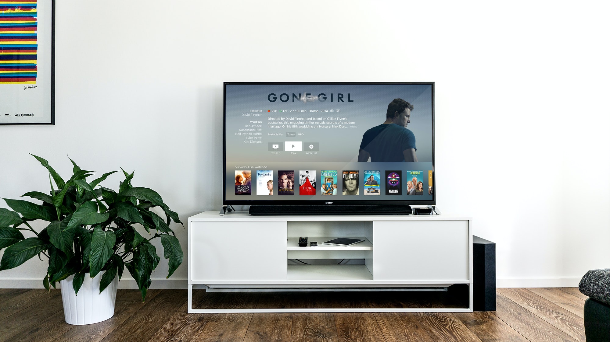white minimalist media console with flatscreen TV on top in sunlit living room